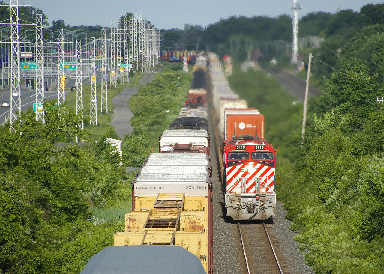 BC Rail heritage unit CN 3115 is leading CN 120 as it passes CN 305 in Beaconsfield. Ironically I passed CN 529 with NS 8103 (N&W heritage unit) leading while en route to get this shot. Unfortunately the power was swapped at Taschereau Yard, so this unit will not be leading CN 120 into Halifax tomorrow morning.