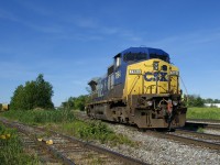 With an end-of-train device in the front coupler and the conductor riding the power, CSXT 7864 is heading to get its train ready before CSXT B763 heads south for Massena, with this single unit running long hood forward the whole way. At left a single boxcar is on the spur of an unknown client.
