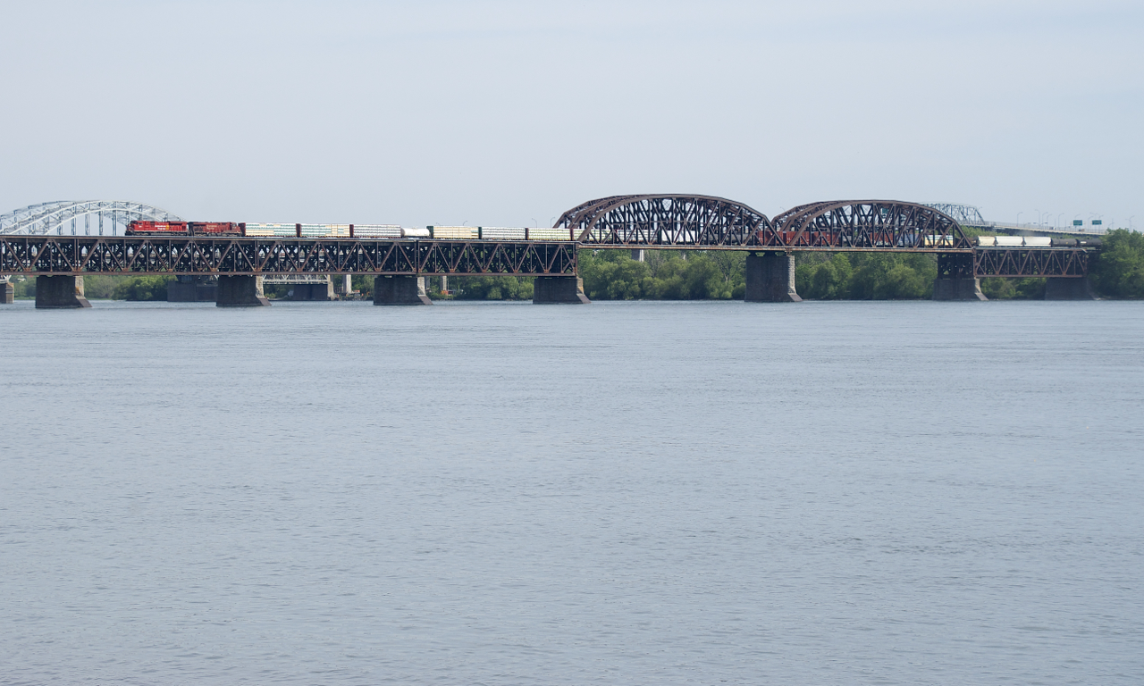 An SD70ACU is leading as CP 251 approaches dry land with CP 7044 & CP 8923 for power.
