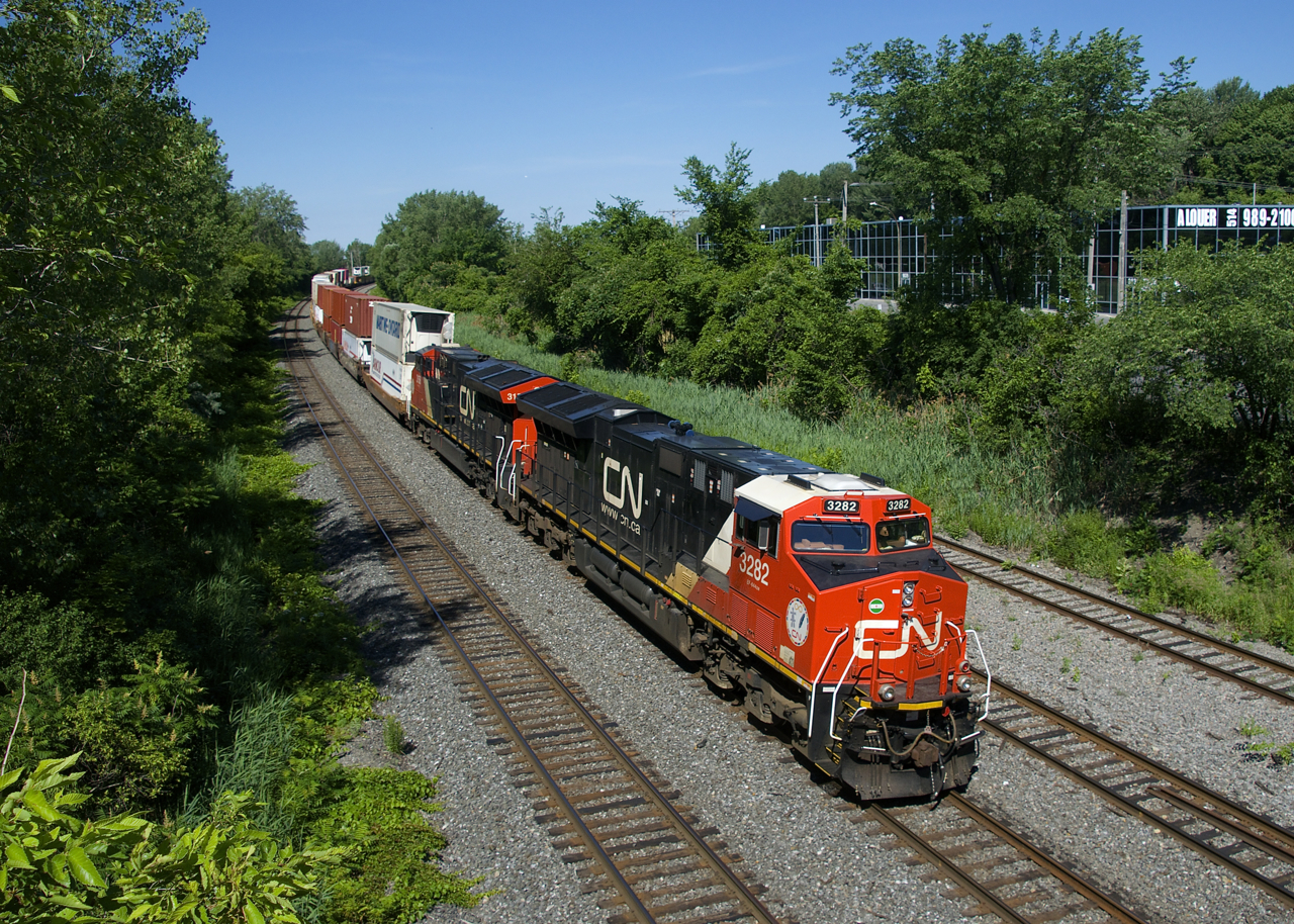 CN 120 has CN 3282 & CN 3158 up front (and CN 2885 mid-train) as it heads east after departing Taschereau Yard. CN 3115 (the BC Rail heritage unit) had led CN 120 inbound into Taschereau earlier this morning, but unfortunately the power was swapped out in the yard.
