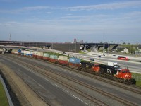 Clean CN 3279 and much dirtier CN 2885 are on the head end of CN 121 as it passes the recently rebuilt Turcot interchange. Mid-train is CN 3164.