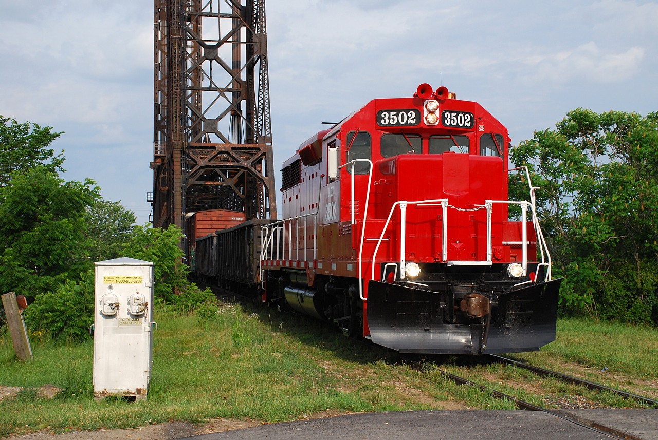 Spiffy JLCX 3502 leads the northbound Trillium Railway train to St. Catharines across the old Welland Canal and in to Dain City.  The two gondolas would be dropped off at a customer in Welland, leaving only the two boxcars to continue on to St. Catharines.  The GP35 started life as Denver & Rio Grande (DRGW) 3036.