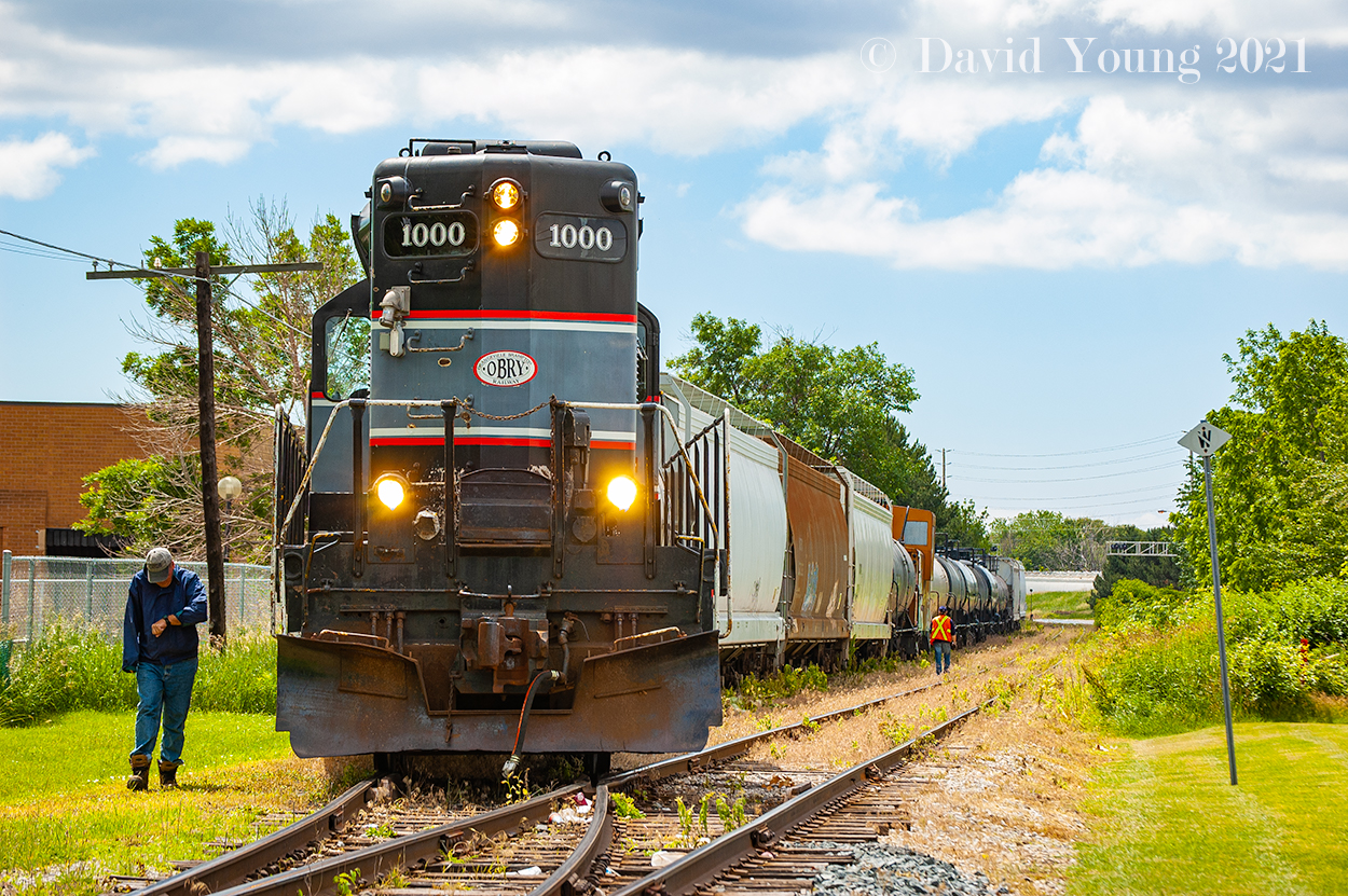 In 2021 time is ticking down for the Orangeville and Brampton Railway however back in June 2008 it was just another day for the Cando crew. Having delivered their outbound traffic on the south end of the interchange, the crew has coupled up to their Orangeville bound traffic. The hogger checks his watch prior to re-entering his steed, while the conductor walks to make the cut at the old CP caboose (now known as a "riding platform"). Once back in Orangeville, they will make a couple moves in the yard before heading to the industrial trackage at the "north" end of town to switch a couple customers before tying up for the day back at the yard.