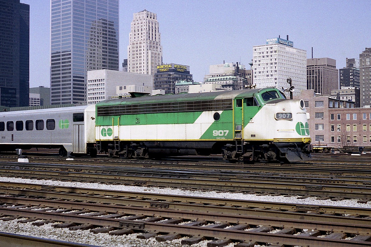 These mostly former Ontario Northland FP7A units are now long gone from GO.  Still, I find it hard to believe that this particular one was scrapped over 25 years ago. While it doesn't exactly seem like yesterday when they were all over, but it just doesn't seem THAT long ago.  I've always liked them.   GO 907 was the former ONR #1504 and was scrapped in 1995. This GMD APCU was one of 11 on the system at the time, and the power unit on the west end was GO 701. I recorded the time of this photo as 1032hrs on a Sunday. I guess even back then I wasn't crazy enough to try shooting here during a weekday.  Now........it is all off limits. I wouldn't even have an idea where one could park around there any more.