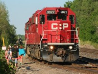 Back in the day many years ago you would see the odd person with a fishing pole or a cooler heading towards the quarry near the west end of Guelph Jct. Last summer while photographing OSR coming back from Guelph I remember pulling-up to the crossing and thinking to myself, there were certainly a lot of railfan’s wanting to shoot this as well. I couldn't have been more wrong as it turned out all the cars parked along the road where either people heading to the quarry or returning. There wasn’t another railfan around. For almost an hour I watched as the seemingly endless parade of folks either walked along the ROW with coolers, beach gear and eventually even ATV’s heading to the popular quarry or back to their vehicles. Man how times have changed. 
<br>
Here CP T69 builds its train to head back west with 3022, while OSR completes its last moves of the day in the background while the steady stream of people continue their way to the nearby quarry during a humid summer evening.
