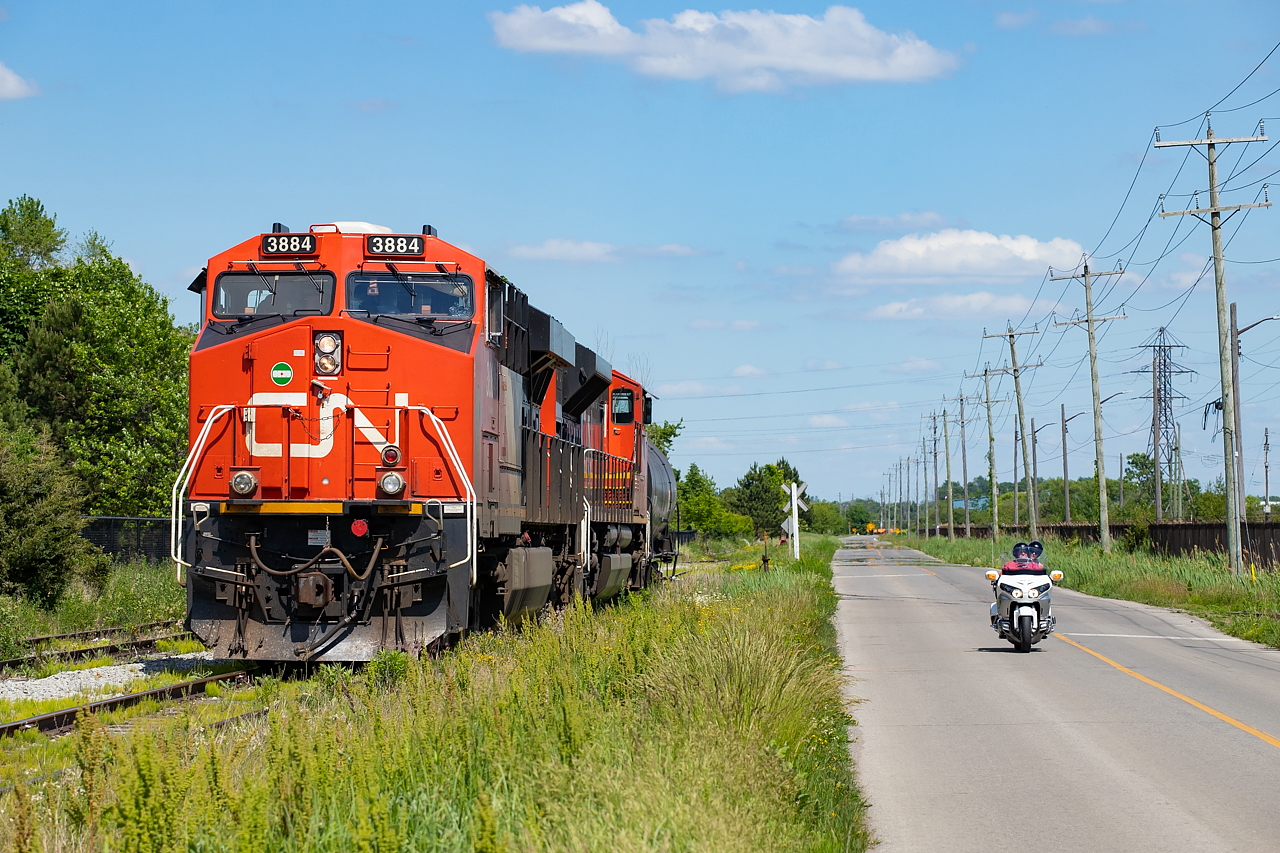 CN L562 and a couple of people out for a nice Saturday cruise squared off in a rather unevenly matched drag race down in Port Colborne, making for this scene. Should have put a loaded tank behind the bike to even things out, I suppose.
