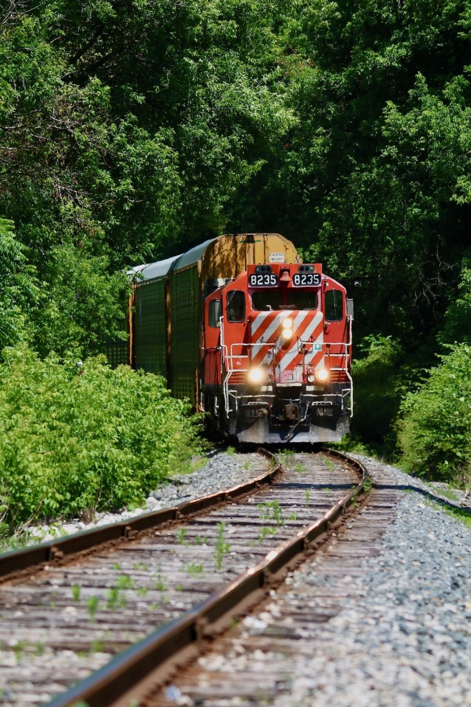 Summer heat waves are very apparent as OSR's Woodstock job returns back to Ingersol after a run to the CP interchange. The crew have brought their train to a stop just before the connecting track to CN as they wait for two of OSR's "pups" SW1200's to return with a cut of cars. From here both jobs will head over to the large CAMI plant on the west side of town to work loaded and empty auto racks before ending their days.
