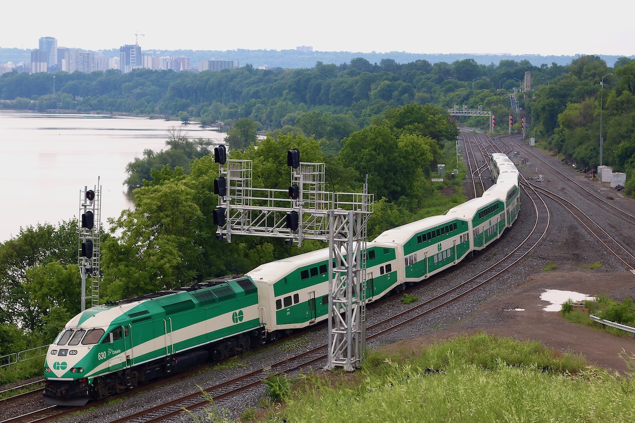 This is a relatively new vantage point in Hamilton, unfortunately sunny days do not work too well for this angle, so Saturday's dreary weather worked out well for this shot. This was a somewhat interesting GO train, being that it was the first of the summer Niagara Falls trains complete with bicycle equipped passenger cars. The windows of the cars for this service have bicycle images on them. The train is working its way through Hamilton junction, with the "cow path" and CP's Hamilton subdivision entering to the right and the Hamilton subdivision departing in the distance under the high level bridge.
