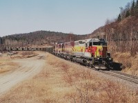 WC 6001, 6590, 2252 and 2052 pulls away from the harbour facilities (on Lake Superior) with ore loads for the steel company in Sault Ste. Marie. This image was taken shortly before the operation shut down for good. Tracks for the sub were then pulled up in 2000.  Michipicoten Harbour then slid back into being somewhat of a ghost town compared to its past heydays of 25 homes, a store, a school and so on...........now, just a few homes and cottages. Superior Aggregates I understand is opening up a trap rock mine in the area, so the community may very well be reborn once again. Lead unit 6001 renumbered for new owner Wisconsin Central, but is still in Algoma colours.