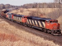 This was certainly a place I could never get sick of back in the day. Before the big golf course was built here, this location was surrounded by rolling farmland. The ten minute hike up the hill was always worth it and a lot of friendships were built around mile 30. I always loved the Draper years on CN and this day presented me with one of my favourite shots from this location. Trains 334/335 were always interesting and often had NS power out of Buffalo on it. Unfortunately the Niagara region traffic gradually dried up as it was rerouted, much of it was relocated to and from Montreal instead of Toronto. This day three cowls in the form of a SD50 and 2 Dash-8's are in charge of train 335 as it rolls through the dormant landscape at mile 30.