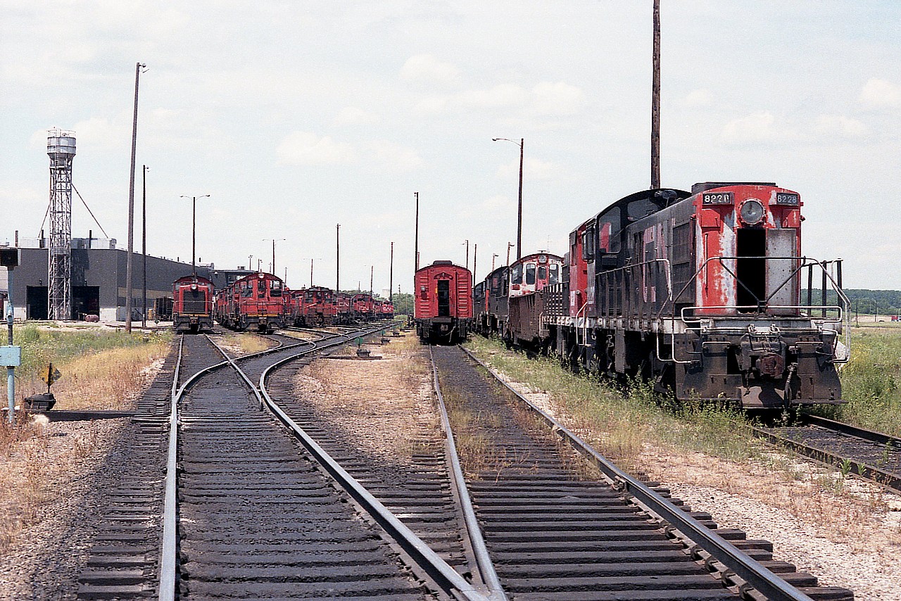 A view looking toward the engine facilities in Mac Yard back in mid 1984. Closest two units on the right are MLW S-7s, retired; numbers 8228 and 8230. Just another day at Mac.