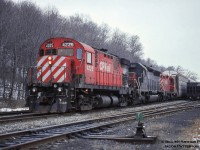 A dreary winter day finds a leased unit trailing at Kinnear Yard on train 520 in the form of SD45-2 HATX 917, the former SP 9106 (built 1969).  The unit appears to have gone to G&W as HCRY 459 by 1998 (working on BPRR), and still operates there today, renumbered circa 2015 <a href=http://www.rrpicturearchives.net/showPicture.aspx?id=4545240>to BPRR 3063,</a> and at some time rebuilt to an SD40M-2 retaining the SD45 carbody.<br><br>The 4225, built by MLW in 1965, would be retired about a year and a half later in September 1996 and scrapped by American Iron the following year.  The 8211, built as 8663 in 1957, would be declared surplus in 2015, sold to RTEX 8211, later to Northern Plains Railroad of North Dakota as 8211 the same year.<br><br><i>Bill McArthur Photo, Jacob Patterson Collection Slide.</i>