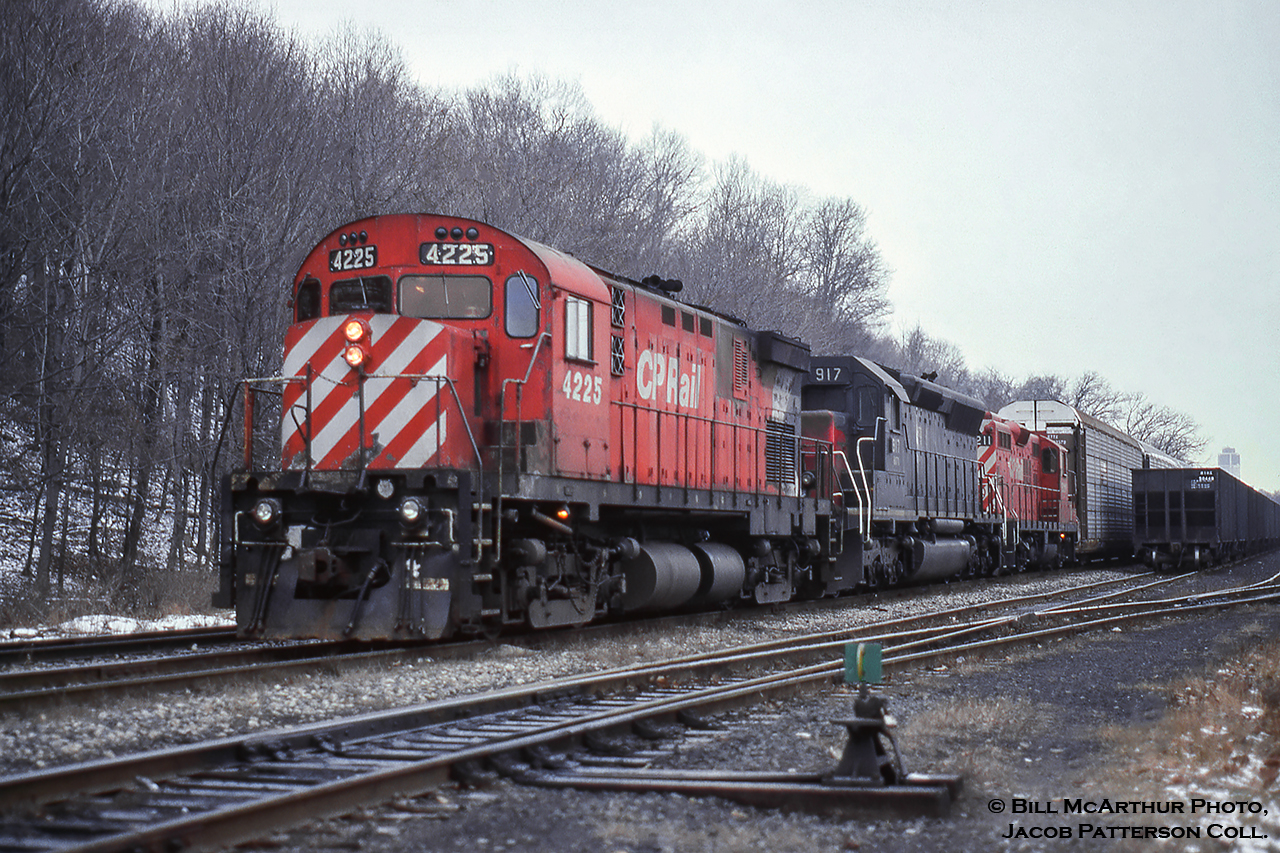 A dreary winter day finds a leased unit trailing at Kinnear Yard on train 520 in the form of SD45-2 HATX 917, the former SP 9106 (built 1969).  The unit appears to have gone to G&W as HCRY 459 by 1998 (working on BPRR), and still operates there today, renumbered circa 2015 to BPRR 3063, and at some time rebuilt to an SD40M-2 retaining the SD45 carbody.The 4225, built by MLW in 1965, would be retired about a year and a half later in September 1996 and scrapped by American Iron the following year.  The 8211, built as 8663 in 1957, would be declared surplus in 2015, sold to RTEX 8211, later to Northern Plains Railroad of North Dakota as 8211 the same year.Bill McArthur Photo, Jacob Patterson Collection Slide.