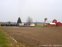 After departing Tillsonburg, the second last OSR train on the Cayuga is westbound heading toward Aylmer passing James. S. Howie and Sons farm. It was a real treat that the last two (OSR) trains on the Cayuga were F units, given the Wabash plied this line with F units for 30 years. This railway's future is still uncertain as it has not yet been ripped up by CN. While the weather was gloomy for both last runs with F units, this angle was only possible on a cloudy day.