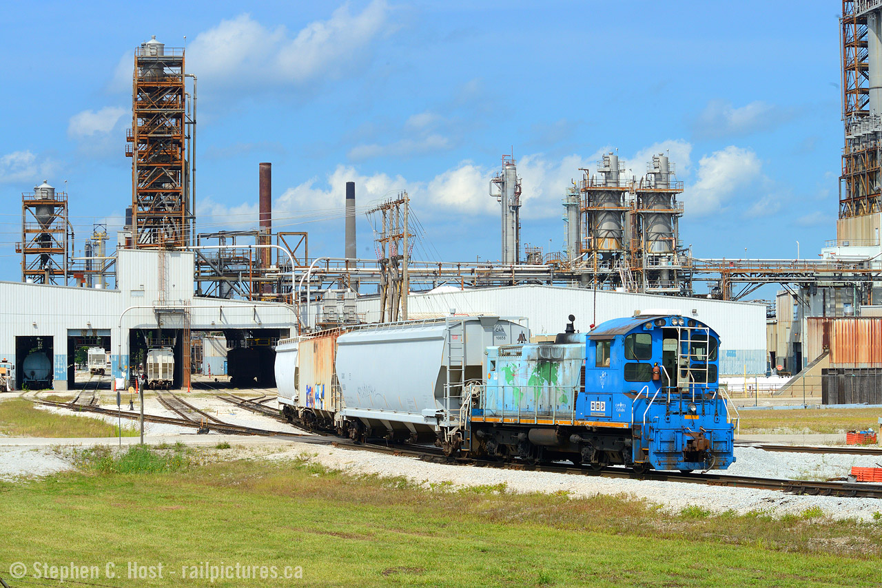 One thing I must say is I often have a habit of doing something, just before it changes , without knowing it is about to change. This is another of those occasions. In 17 or so years going to Sarnia trotting around the industrial areas with a camera I've only managed to see something here twice, and yeah, it's private property, but the roads wide open, get a quick shot and don't loiter. Right? It was right in front of me after all. This engine, Electro-Motive Canada 1, formerly GMD 117 nee EMD 117, SW1001 built in 1979 by .. EMD, was once based out of London at the GM plant, and while I saw the damn thing in London you'd think i'd have a photo of it, I did tour the damn plant twice but I didn't get it on camera then. So this was my opportunity as it's been assigned here for years and engines are normally parked at the security gate. Obviously it's not owned by EMD anymore in this picture, in fact it is owned by Lambton Diesel Services of Sarnia. What changed? They painted the damn thing so this "Quality Built Locomotives for the 21'st century - 50 years" commemorative scheme is now gone. It's now in typical Black dip LDS paint and now numbered 1001, so I found out this past weekend. While I don't regret that I have  shots of it to share, this piece of EMD/GMDD history is basically not the same. Anyway, this is Imperial Oil plant #3 which makes plastics, and they previously had ex CN 7920 here before this in a nice Esso scheme - Jay told me a story (might be on this site) that after taking this picture security tapped on his shoulder and told him off. Brave soul as engines are parked right beside the gate. Today 1001 and 1391 (ex JLCX) are parked in the same spot.

Oh and about 7920, they swapped it with #1 like 8 or so years ago and 7920 languished beside the LDS shop, in this paint scheme largely untouched. On the weekend I noted the ESSO logo is now blanked out (primer) and the prime mover has been removed from 7920 so it seems to have been used for a major transplant recently. Oh well, get your shots, because change is always just around the corner. 
I still wish I got a good shot of #1 at GMDD London, but the one time I took pictures of the EMD plant in London, I see a trackmobile in the photo attached to a large new primer locomotive.. so I'm debating when it was taken out of service in London or when last used. Comment below if you know.