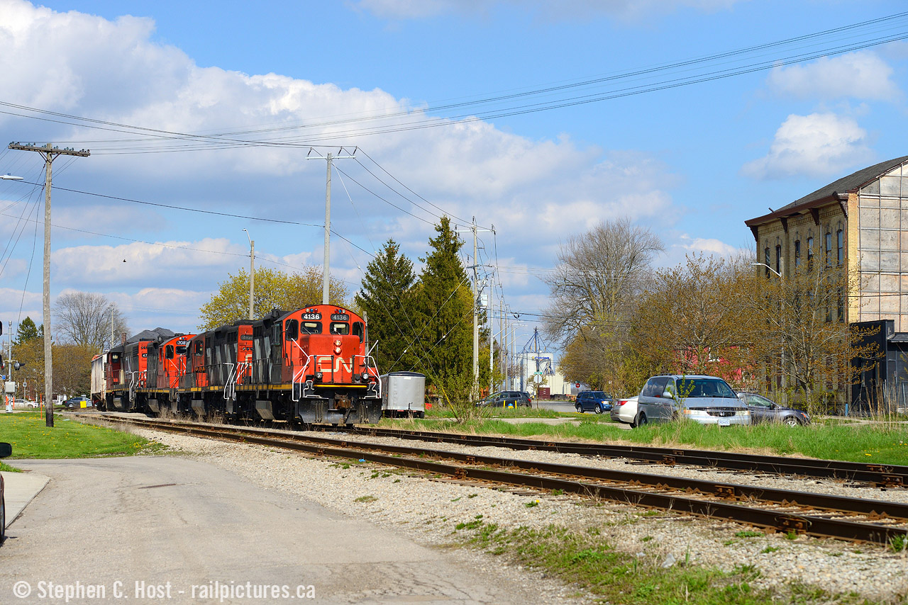 Switching the yard lead and sandwiched between Cobourg lane and Kent St, L568 is working on their set off in Stratford yard while the town and railway seem integrated, not separated. Believe it or not the foreground track is the Guelph subdivision mainline, and just to the far left is Stratford West where the GEXR Goderich sub branches off. A quaint scene reminiscent of many branchline towns north of here, long gone. Fencing and other safety measures are sure to eliminate the rural look of this scene in due course - it's already happened in Guelph and Kitchener.