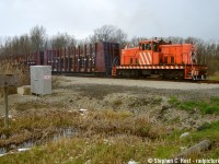 In response to <a href=http://www.railpictures.ca/?attachment_id=45747 target=_blank>Arnold's photo in 2009 </a>, here's a contemporary view of action on this spur. Crossing Highway 140 on the former NYC/PC Caso Subdivision, this segment was cut off in 1974 for the new Welland Canal. 615 (Named after 615 Rusholme Road, address of the facility as per Mr. Knott), nee #7, nee Stelco 53 has 5 loaded pipe cars from Welded Tube Welland and blasts their interesting horn as they head to Southern  Yard. It's interesting how at first look, not much has really changed when you glance at all this, but when you dig deeper so much has at this location. The Universal Resource Recovery signs are still up at the "martech" facility.. as are the Martech signs... you can peel back the decades of history just walking around the property. The Welland Pipe sign is nearly faded completely at left in this photo. The company names keep changing but rail operations have been largely the same!


