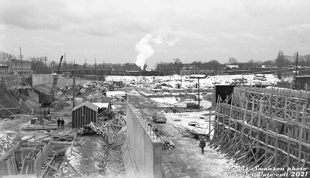 Lewis Swanson was another one of the local Toronto area transit photographers back in the day, and took a lot of photos of the Yonge Subway line under construction in the early 1950's, Toronto's (and Canada's) first subway. Many pointed their cameras mostly at vehicles, but Mr. Swanson also took many photos of infrastructure, terminals, signs, and station areas most others would often overlook (notable since in the film days each photo cost money to take). From what I've been able to gather, he was active taking photos from the late 40's until the mid-80's (in later years, mostly during CNE visits).  The view here is looking south from Chaplin Crescent at the TTC's new Davisville subway yard and shops under construction. Land has been cleared, forms are up, and concrete is being poured for buildings, platforms and retaining walls (note along Yonge Street on the left). Tracks would be laid starting around early 1953, and everything would be in place for taking delivery of new Gloucester subway cars (on flatcars via the Belt Line) beginning around September 1953, and for the official opening day on March 30th 1954 (see 1957 aerial here for completed yard). This would be the main subway yard for storing and servicing trains on the Yonge and later University lines until the opening of Wilson Yard on the new Spadina Line extension in 1978 (development and properties on all sides of Davisville constrained expansion of the yard).  In the background, a CN steam engine switches on the old Toronto Belt Line Branch with a cut of 40' boxcars and reefers. Belt Line customers to the east of Yonge Street included Dominion Coal & Wood at Mount Pleasant, and a lumber yard or two along Merton (the double door boxcars are probably for one of the lumber yards). There was also an Elias Rogers coal dealer on the right in the background on the south side of the tracks (site redeveloped with apartment buildings by 1960).  The berm the steam loco is on would soon be replaced with a bridge spanning the future TTC Davisville Yard tracks that would run underneath the line. While the CN Belt Line was abandoned east of the Spadina Expressway in 1970 and removed, the city wasted no time and bought the right of way for the present Kay Gardner Beltline Trail. Much has changed here, but the CNR plate girder bridge visible under the boxcars still exists today spanning Yonge Street.  Lewis Swanson photo, Dan Dell'Unto collection negative (large-format scanned with a DSLR, with some restoration work done).  More around Davisville: New H1 subway car delivered via the Belt Line: http://www.railpictures.ca/?attachment_id=32616 H4's departing the north end of the station: http://www.railpictures.ca/?attachment_id=34861 Modern view circa 2007: http://www.railpictures.ca/?attachment_id=24613