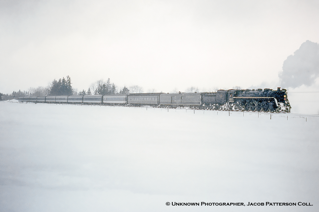 With such warm weather here's a shot from a much cooler day, -8°C with the wind chill at London, ON International Airport.  Seen during the first of two UCRS "Farewell to 6218" Excursions running the weekend of March 20 - 21, 1971, U-2-g 6218 passes Kelly's siding south of Belmont, ON on one of her two photo run-bys on this day.  This trip would run Toronto - London via Guelph and return via the Dundas Sub.  The following day would be the final UCRS trip with this engine, running Toronto - Guelph - Lynden - Paris Jct. - Caledonia - Hamilton - Toronto with a farewell banquet held in the James Street North station in Hamilton.  Further information found in the April, 1971 issue of the UCRS newsletter.Original Photographer Unknown, Jacob Patterson Collection Slide.