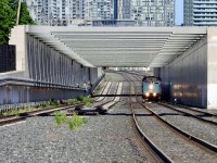 London bound via the "back way" VIA #87 is just about to negotiate the crossovers under the Strachan Ave overpass. There have been many changes in this area over the past 40 plus years. Long gone are Cabin D (preserved at the John St roundhouse), the Spadina coachyards and the infamous former site of Toronto's malodorous slaughterhouse/abattoir. The 2 tracks to the left will become part of the double tracked Newmarket Sub.