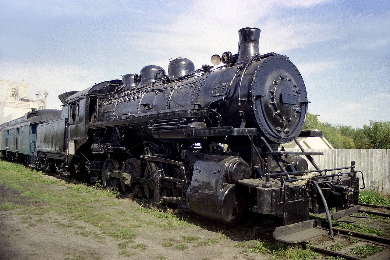 It has been a long time so I do not recall exactly where the Strathcona Restoration facility was. South Edmonton along Hwy 2 I think it was back then. However, I did stop and grab a photo of an old steam engine coupled up to Intercolonial baggage car #236, which is what caught my attention in the first place. In 1970 this steam engine went to the Alberta Railroad Museum in North Edmonton. Eventually it was then sold.  After many years, in 1998 the old CP 0-8-0 steam came to rest down near the ghost town of Sandon, BC; I gather on the outskirts of Kaslo; where it is on permanent historical display and kept in reasonable condition (non-operational, of course). The steam engine was built in 1908 by MLW as 2-8-0 #1737 but went thru a rebuild @1928 as an 0-8-0. Interesting it cost new $18,422 CDN  back in 1908 and now $250,000 has been put into it for restoration. Great comparison of how the dollar has changed over the years.