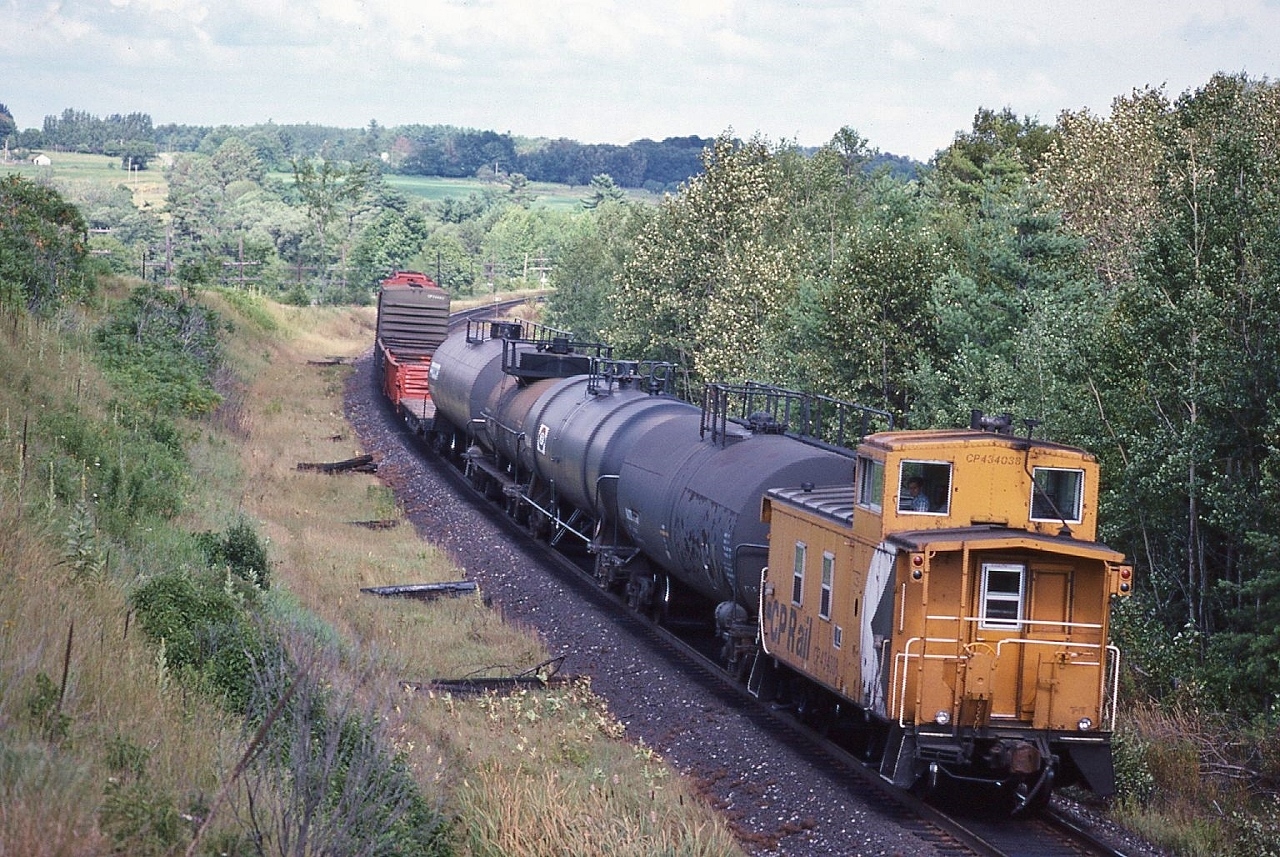 A pair of SD40's power the Trenton Turn through Wesleyville,


   as the Conductor / Brakeman checks out the photographer
  

   July 20, 1986 Kodachrome by S.Danko
