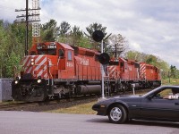 <br>
<br>
   For twenty five years – more or less -  the GMD SD40-2 was CP Rail's  'standard road power',
<br>
<br>
   a trio of SD40-2's was, well, a common sight, such as here, with 5904 - 5788 – 5673 
<br>
<br>
   CP RAIL Extra 5904 South  has completed the set-off – the lumber load seen at extreme right - and is returning to train (
<br>
<br>
   The marker lights are illuminated indicating an 'extra'.
<br>
<br>
   At mile 114.7 Mactier Sub on a steamy July 1, 1988, Kodachrome by S.Danko 
<br>
<br>
   For the record, my 1991 Trackside Guide ( for the 1990 rail year ) records CP Rail owning 79 SD40; 480 SD40-2; 25 SD40-2F (the latter 1988 builds', missing the CP Rail 'The Canadian' by a mere 9 years or so....imagine a 9000 leading 'The Canadian' through Morant's Curve.....) 
<br>
<br>
   And as at 1990  zero, nada, zilch  GE's on CP Rail's roster. (  GE era commenced 1995 )
<br>
<br>
   ( and at 1990 CN had  a lonely six GE boxcab electrics built 1914 and three built 1950; and CN had 30 new  GE Dash 8-40CM's # 2400-2429 built that year ).
<br>
<br>
  and that appears to be a mid 1980's Nissan 300 ZX Turbo.....I am certain someone out there can confirm....
<br>
<br>
    …..so....imagine a 9000 leading 'The Canadian' through Morant's Curve.....
<br>
<br>
   sdfourty


