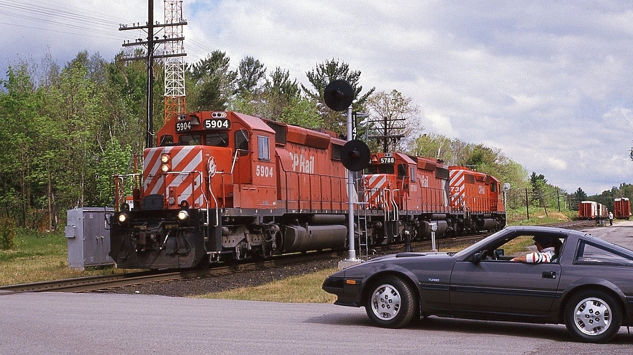 For twenty five years – more or less -  the GMD SD40-2 was CP Rail's  'standard road power',


   a trio of SD40-2's was, well, a common sight, such as here, with 5904 - 5788 – 5673 


   CP RAIL Extra 5904 South  has completed the set-off – the lumber load seen at extreme right - and is returning to train (


   The marker lights are illuminated indicating an 'extra'.


   At mile 114.7 Mactier Sub on a steamy July 1, 1988, Kodachrome by S.Danko 


   For the record, my 1991 Trackside Guide ( for the 1990 rail year ) records CP Rail owning 79 SD40; 480 SD40-2; 25 SD40-2F (the latter 1988 builds', missing the CP Rail 'The Canadian' by a mere 9 years or so....imagine a 9000 leading 'The Canadian' through Morant's Curve.....) 


   And as at 1990  zero, nada, zilch  GE's on CP Rail's roster. (  GE era commenced 1995 )


   ( and at 1990 CN had  a lonely six GE boxcab electrics built 1914 and three built 1950; and CN had 30 new  GE Dash 8-40CM's # 2400-2429 built that year ).


  and that appears to be a mid 1980's Nissan 300 ZX Turbo.....I am certain someone out there can confirm....


    …..so....imagine a 9000 leading 'The Canadian' through Morant's Curve.....


   sdfourty