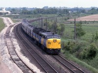 <br>
<br>
   FPA-4 #6781 with a FPB-4 leads train #43 at mile 292 Kingston Subdivision
<br>
<br>
   The original Bowmanville Town spur crossed the 401 at grade – a level crossing -  on the far side of the trees above the train.   
 <br>
<br>
   With completion of the Bowmanville 401 rail overpass ( circa 1983), the newly installed rail access to the Bowmanville Town spur, from the Kingston subdivision mile 291.4  is in place. The spur extended 1.4 miles north from the ( newly installed ) north service track .
<br>
<br>
   The spur was removed some time ago (mid 1990's ?) and the Bowmanville 401 rail overpass was removed overnight June 11, 2011.
<br>
<br>
   At Bowmanville, July 11 1983 Kodachrome by S.Danko
<br>
<br>
   More Bowmanville circa June 1982, look closely, the survey stakes are visible that mark the location of the planned new north service track.
<br>
<br>
     <a href="http://www.railpictures.ca/?attachment_id=  8807">  high speed curve  </a>
<br>
<br>
   what's interesting:
<br>
<br>
   rsd-17 comment March 17, 2013: In my 16 years as a Bowmanvile resident the only time I saw a train on the spur, was a single GP-9 delivering the caboose that is now at Price’s Market (Hwy 2 & Lambs Road.) I didn’t get a shot as it was a dank rainy day and I was on my way to work. On a few occasions I walked through the Goodyear property saw evidence of activity (well cars and flat cars loaded with conveyer belt.) 
<br>
<br>
   notable:
<br>
there were three CNR level crossings east of Toronto on the  original  ‘ Dual Public Highway No. 401 ′ : 
<br>
( 1 ) the Pickering Town Spur, Kingston Sub mile 311.1 ( near the present Brock Road ), extended 0.7 miles north ; 
<br>
( 2 ) the Whitby Town Spur ( the original Whitby & Port Perry Railway ), mile 304.3 ( east of Brock Street ), extended 2.1 miles north;
<br> 
( 3 ) the Bowmanville Town Spur, mile 290.6 extended 1.1 miles north ( as of 1973 ).
<br>
I recall passing over each of the crossings – many times – and as of 1973 all three crossings were in place (and the King’s Highway 401 speed limit was 70 m.p.h. before the Metric Imposition ). By 1979 given the 401 re-build and widening – only the Bowmanville level crossing remained. Interesting was that in town the Bowmanville spur crossed the front lawns (and driveways) of many houses on a street – I believe Hunt Street – north of Baseline Road. 
<br>
<br>
sdfourty