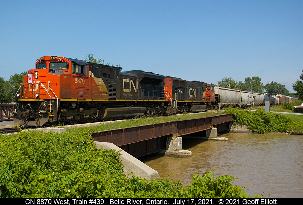 CN 8870 leads a huge train #439 across the bridge over the muddy Belle River in Belle River, Ontario on July 17, 2021.