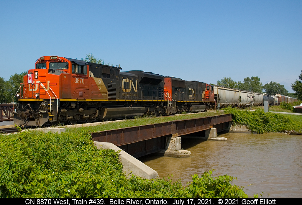 CN 8870 leads a huge train #439 across the bridge over the muddy Belle River in Belle River, Ontario on July 17, 2021.