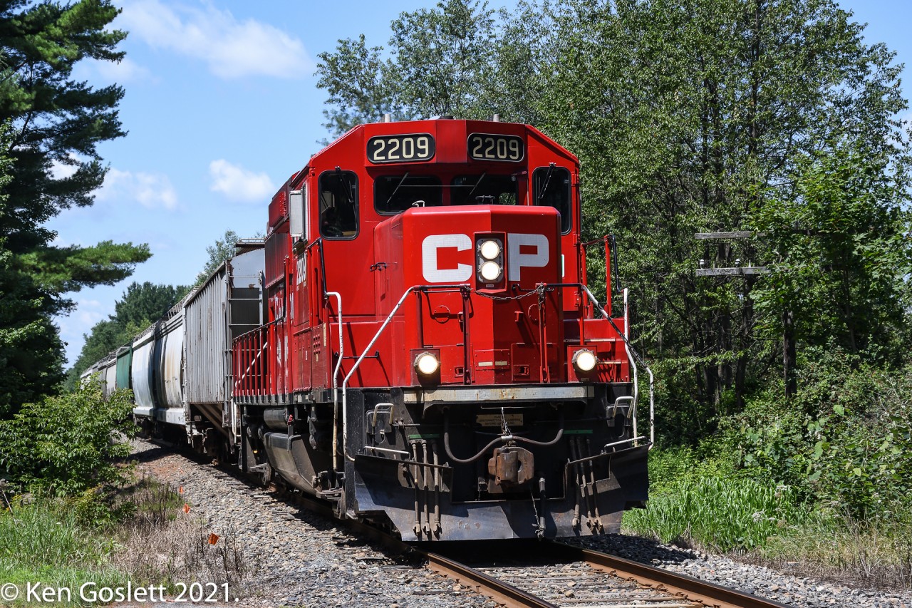 With nine cars in tow CPR 2209 returns to Newport, Vermont from Farnham, Quebec.