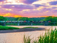 A trio of CN power haul train 406 eastbound as they haul across the trestle at Hammond River, New Brunswick with a colourful sunset filling the sky. June 12, 2021.