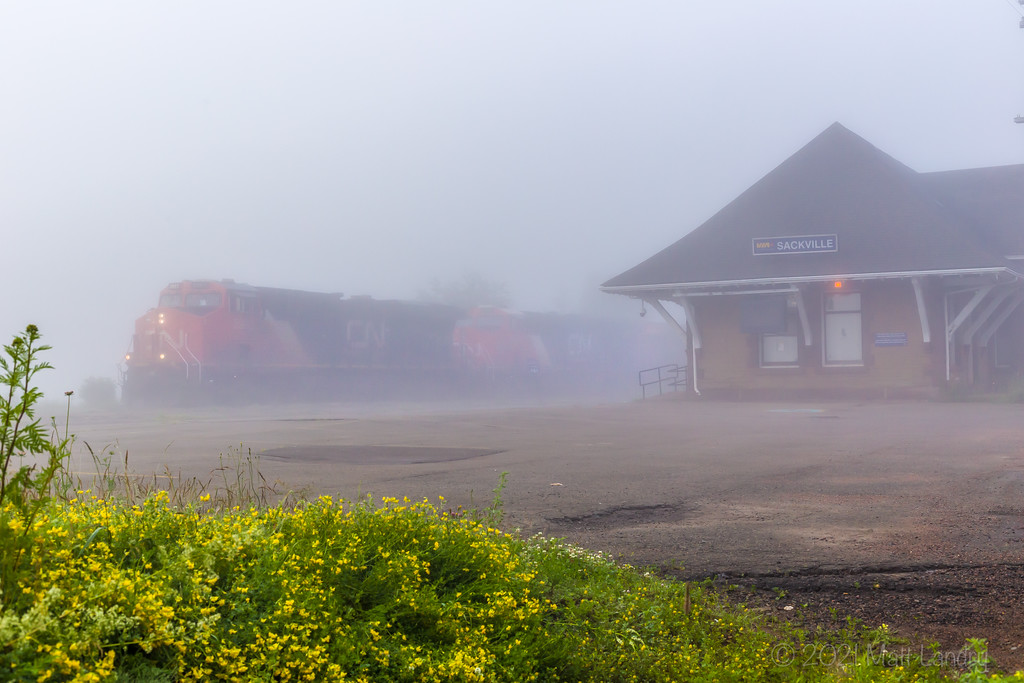 CN 2993 powers stack train 120 through the university town of Sackville, NB during some early morning fog.