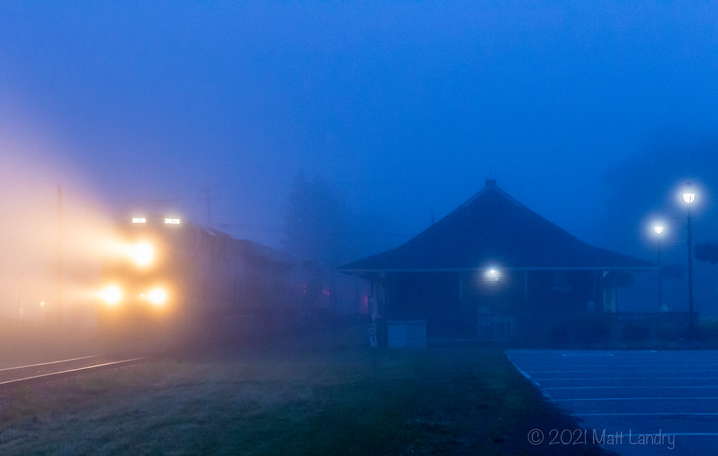 In some killer early morning fog, potash train 730 heads through the town of Hampton, New Brunswick, with a pair of ex CREX ponies at the head end.