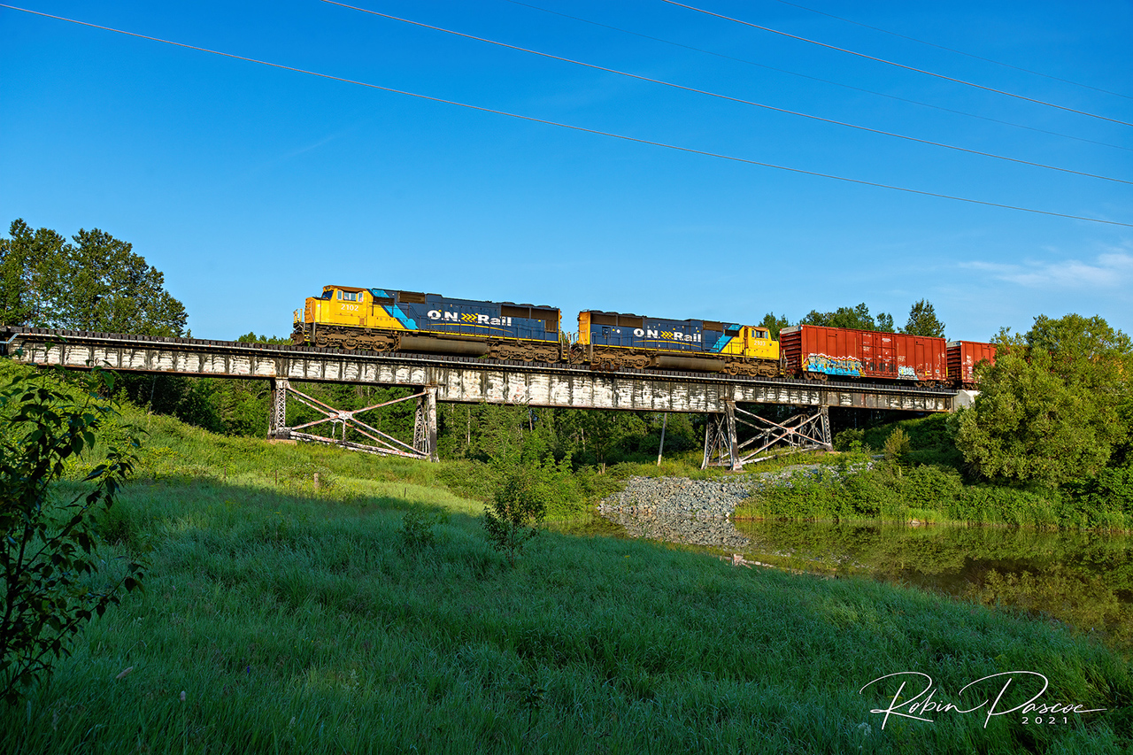 214 makes its way Southbound across one of the Wabi River bridges with back-to-back SD75I's (2102 & 2103).

Near Mile 115.5 Temagami Sub - July 10