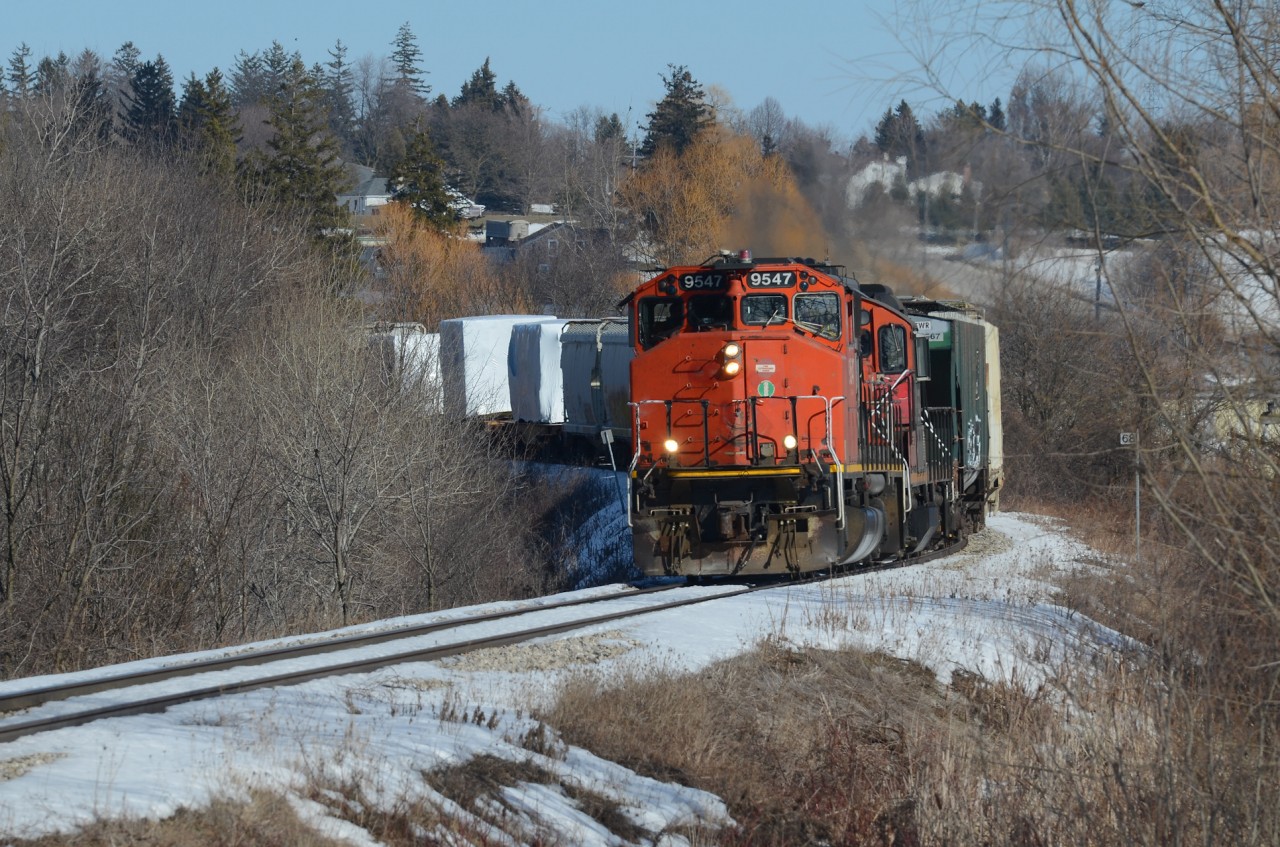 With Snyder’s Rd in the background on the outskirts of Kitchener, CN GP40-2W no. 9547 leads 568 westbound after just cresting the grade out of Kitchener with the pair of iconic Canadian engines still working hard as they curve through the country side beside the Petersburg Regional Forest Trails on a snow covered sunny afternoon.