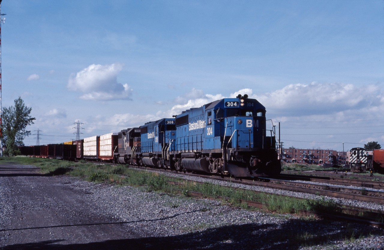 For years, the Napierville Junction's train originated in Rouses Point, NY and ran to Montreal with a couple of MLW built RS2 units. After they were retired, the D&H would assign whatever they had laying over in Rouses Point. After the D&H was integrated into Guilford in the early 1980s, this could include Maine Central and Boston & Maine units--such as B&M GP40-2s 304 and 308, as well as GP39-2 350 (originally built for the D&H). Guilford cast the D&H into bankruptcy in 1988 and by 1991 it was integrated into CP Rail System and run-through operations became the norm.