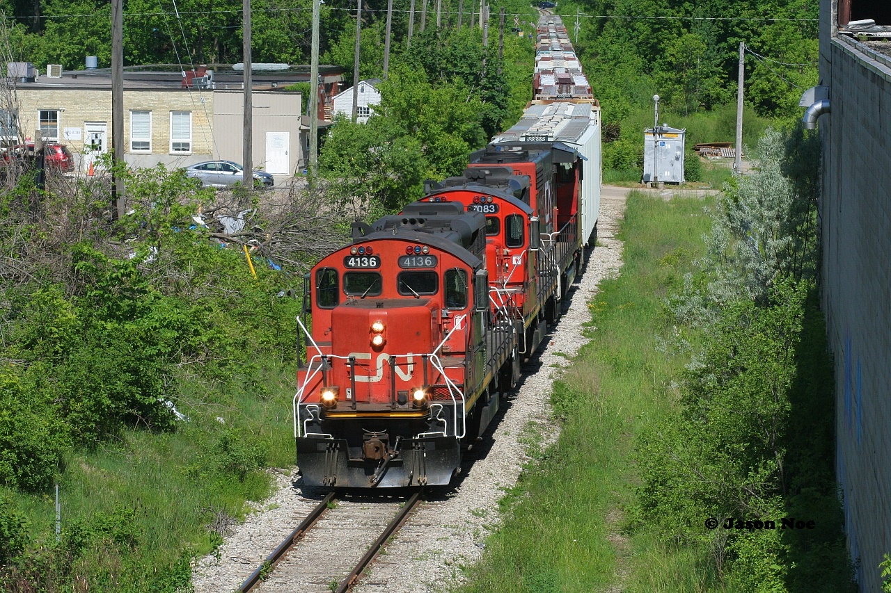 CN L540 has just crossed Madison Avenue in Kitchener as it heads to the interchange with Canadian Pacific on the Huron Park Spur in Kitchener. The consist included; CN 4136, 7083 and 4790.