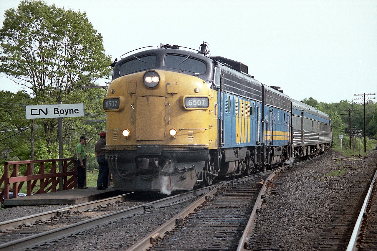 Northbound Toronto section of the Canadian stops for a crew change at CN Boyne, off James Bay Jct Rd N., about 3 miles south of Parry Sound. Immediately to the right out of sight is the CP transcon; namesign CP Reynolds. This location is the beginning of the present day shared CN-CP asset zone which runs just south of Sudbury. Back in 1986 this section of the Canadian crossed over to CP from CN and ran the rest of the way to Sudbury via CP trackage. Power on todays' train is VIA 6507 and 6622.