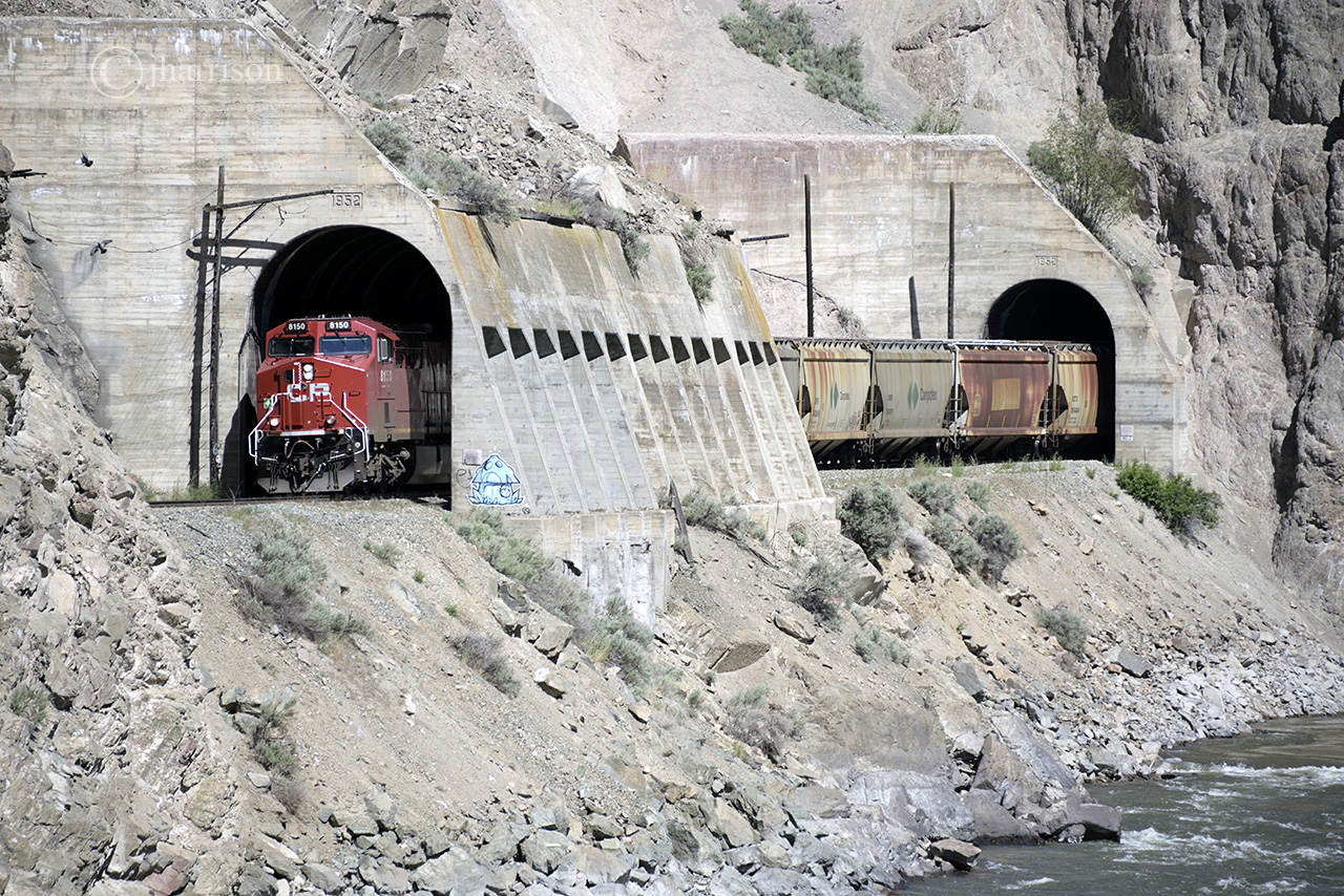 Westbound CP 8150, and trailing in the shed, 8153, at the Skoona Tunnels, Spences Bridge. This little creature appeared within two weeks of my last visit here. The psychology behind graffiti can be easily found online and my attitude regarding the defacing of monumental engineering feats should be taken for granted so, I'll just stick to the logistics. The following shot will show how this is possible.