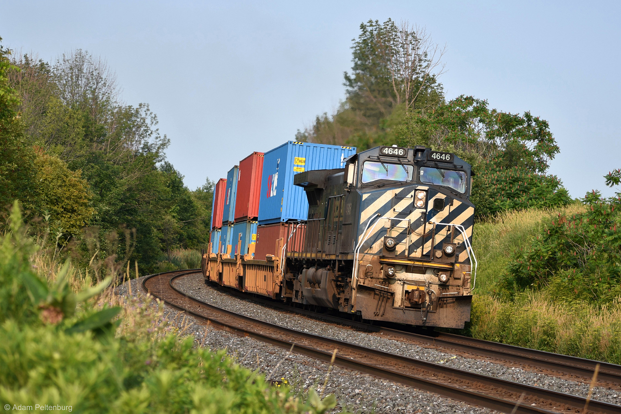 BCOL 4646 accelerates on its way out of Bowmanville in the lead of 108, a "one-unit wonder" without the wonder as the train was noticeably shorter than I would expect. A warm golden sunlight was shining on it through a layer of wildfire smoke from out west. Recently either workers from CN or a railfan armed with a weed whacker bothered to trim the grass on the west side of Bennett Road, making this shot possible again.