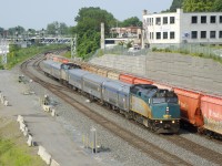 Normally arriving into Montreal late in the evening, the combined VIA Rail train from northern Quebec is now entering Montreal in the morning after a mostly nocturnal run. This is a temporary measure to avoid heat-related slow orders and took place last summer as well. Here VIA 602/606 is passing the tail end of a parked CN B730, its long run nearly done.