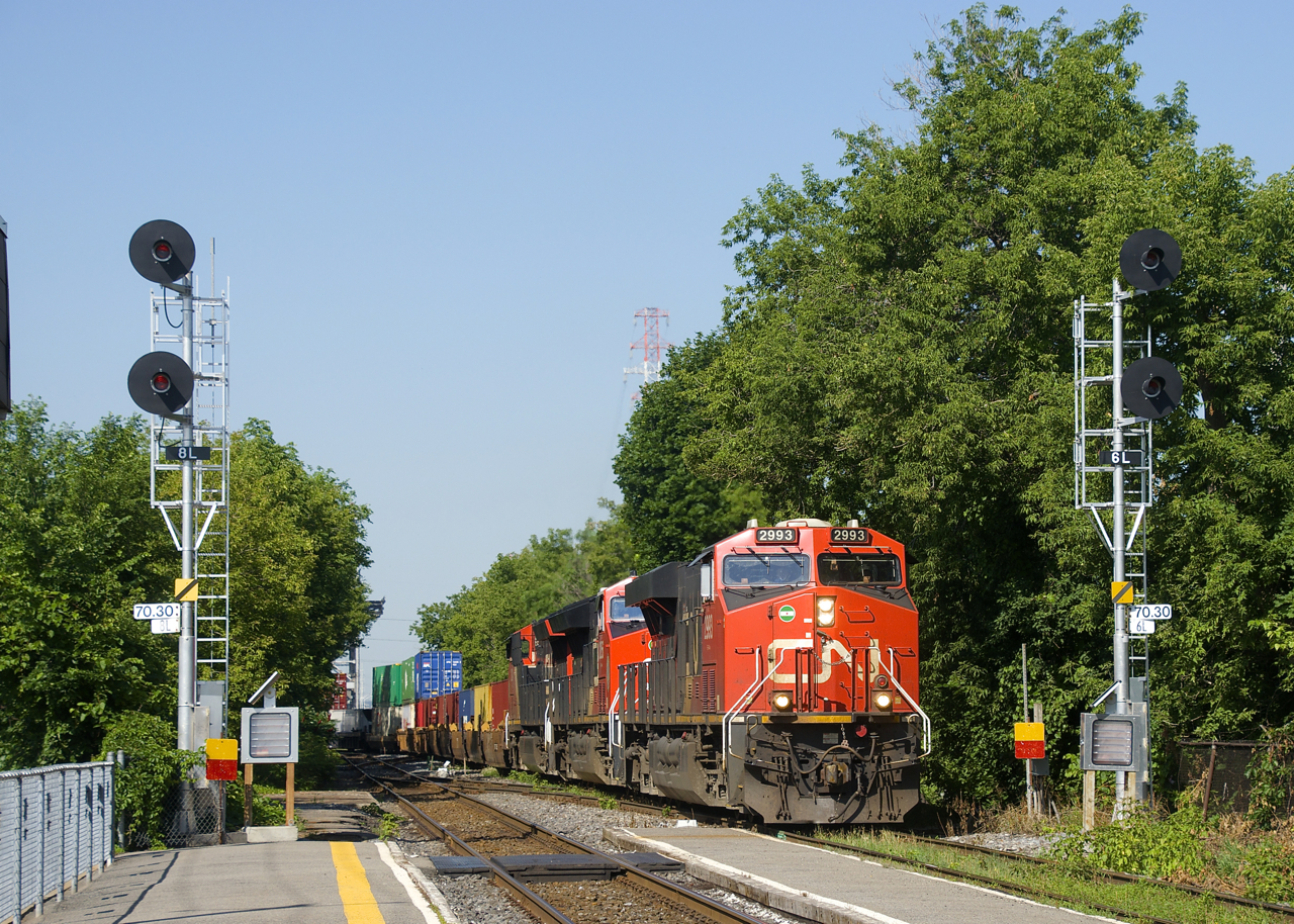 CN 120 has a trio of GEVO's (CN 2993, CN 3256 & CN 3204) and a 614-axle long train as it passes a pair of searchlight signals located at MP 70.3 of CN's St-Hyacinthe Sub. Interestingly enough these signals are only a few years old and replaced a signal bridge that had older searchlight signals.