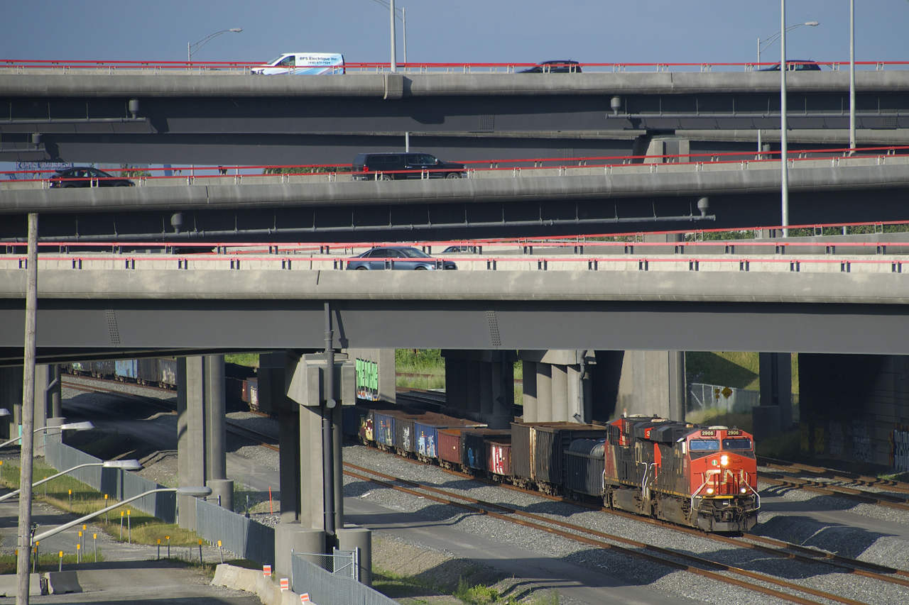 CN 321 is passing underneath the rebuilt Turcot interchange with CN 2906 & CN 3865 for power.