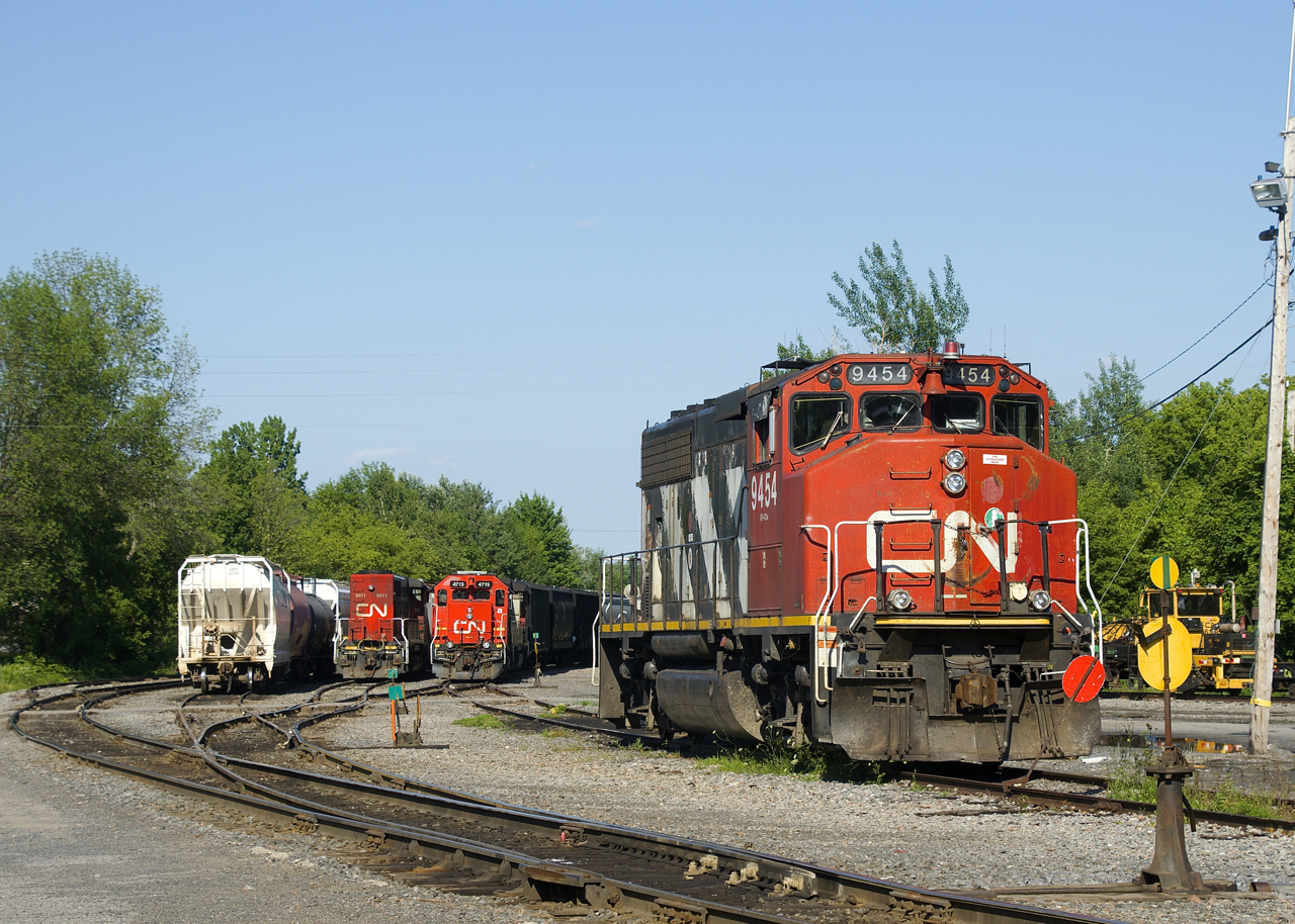 GMD power is parked behind the Coteau Station, with CN 9411, CN 4715 and CN 9454 visible (CN 4802 is out of sight behind CN 4715). In not too long the crew of CN 536 will come on duty and start their work with CN 4715 & CN 4802 for power. They will also couple CN 9411 to CN 9454.
