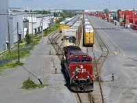 CP 112 is arriving in Lachine IMS as it passes tracks full of stored autoracks. 