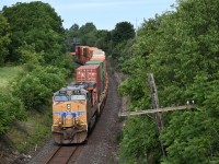 An American visitor pushes from the rear of CP 113 at dawn, rounding a sweeping curve through the southeast end of Oshawa and passing underneath the old wooden pedestrian bridge at Farewell Street in the distance.