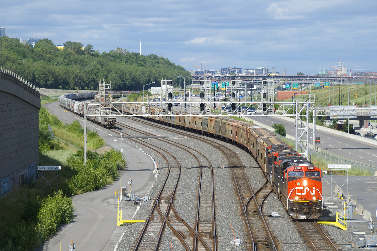 Empty potash train CN 731 has a new crew onboard and is about to depart Turcot Ouest with CN 3872, CN 2906, CN 2808 and 206 cars. At left is a large cut of grain cars.