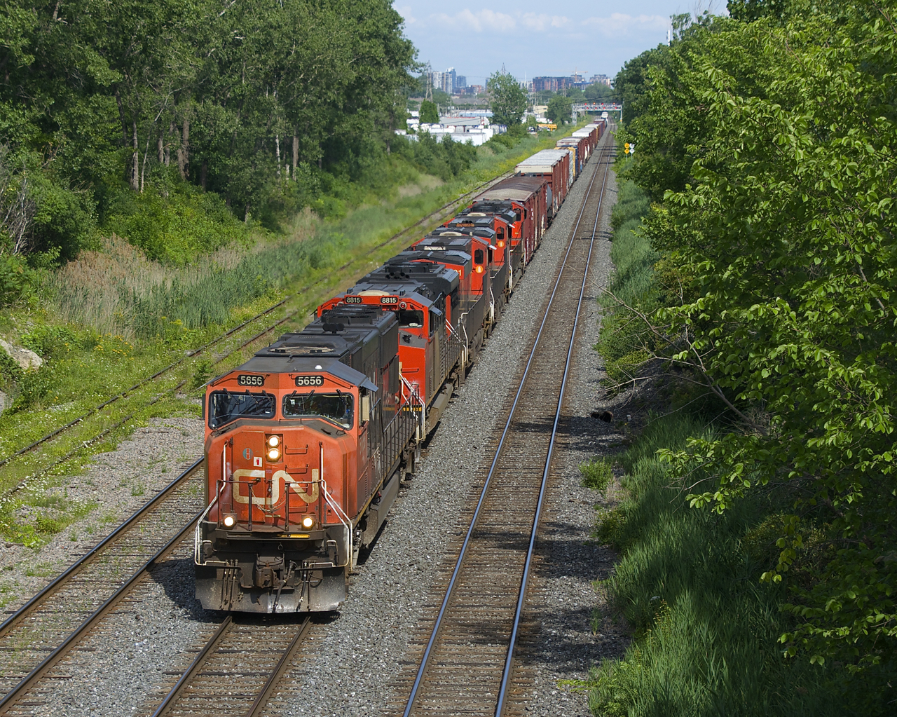 CN 527 has five units (CN 5656, CN 8815, CN 2901, CN 2906 & CN 8840) and 88 cars as it approaches Taschereau Yard.